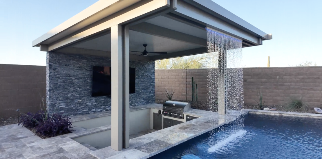 Beautiful backyard pool with a custom waterfall feature