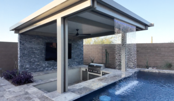 Beautiful backyard pool with a custom waterfall feature