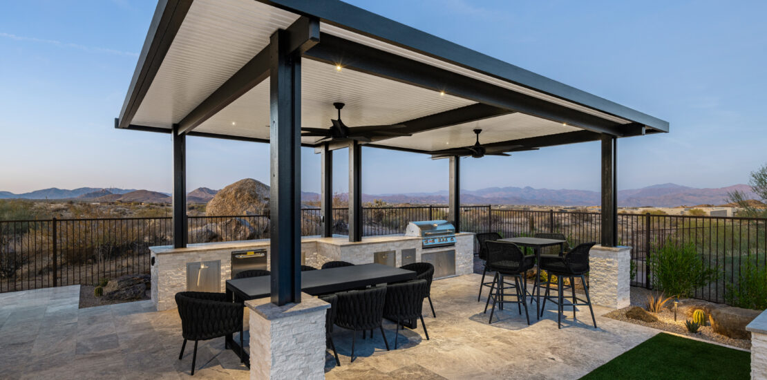 Outdoor kitchen with BBQ, patio cover, and turf